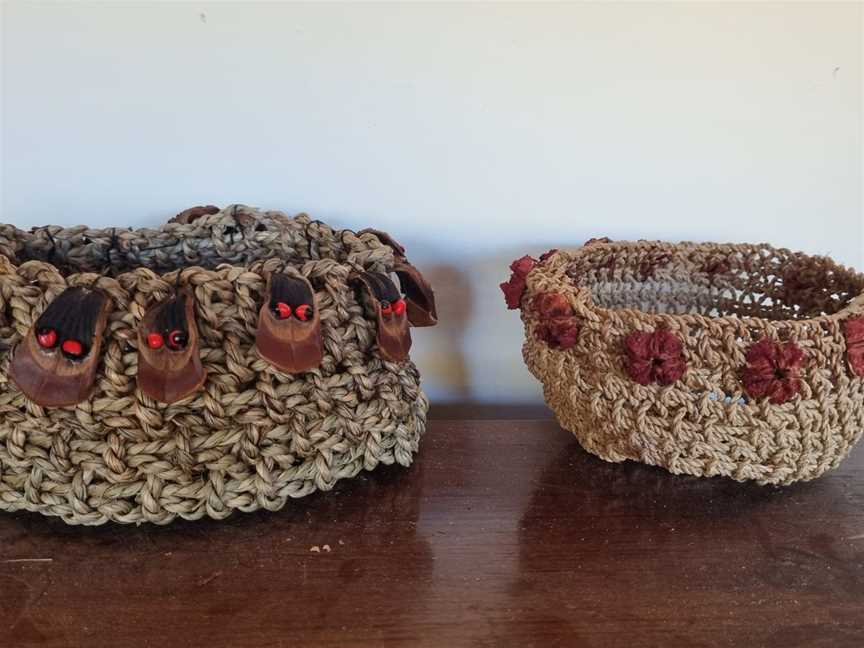 Netted seagrass bowls adorned with seed pods and stone pine sheaths.