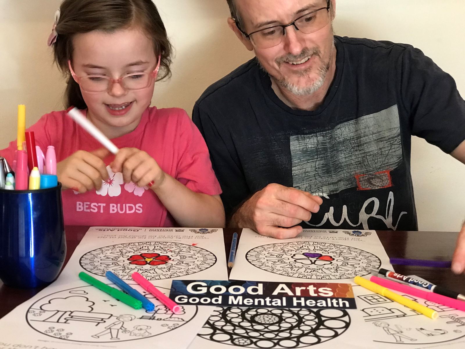 Man and daughter colouring