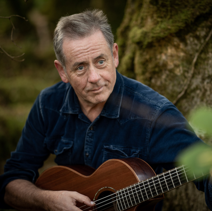 Festival Irish performer, Luka Bloom with a guitar